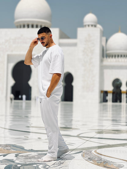 model in a white outfit standing in front of cheikh zayed mosque  wearing xxxl 