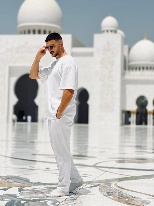model in a white outfit standing in front of cheikh zayed mosque  wearing xxxl 